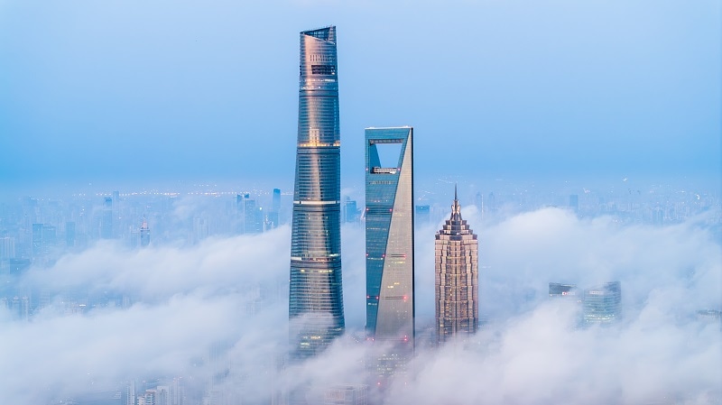 Shanghai skyscrapers rising through the clouds
