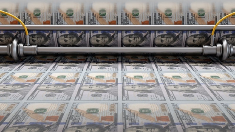 Photo of $100 bills on a currency printing press