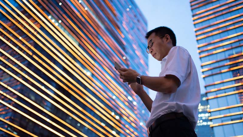 Man in Shanghai using a smart phone.